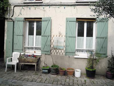 East Paris Green shutters in the cobble courtyard